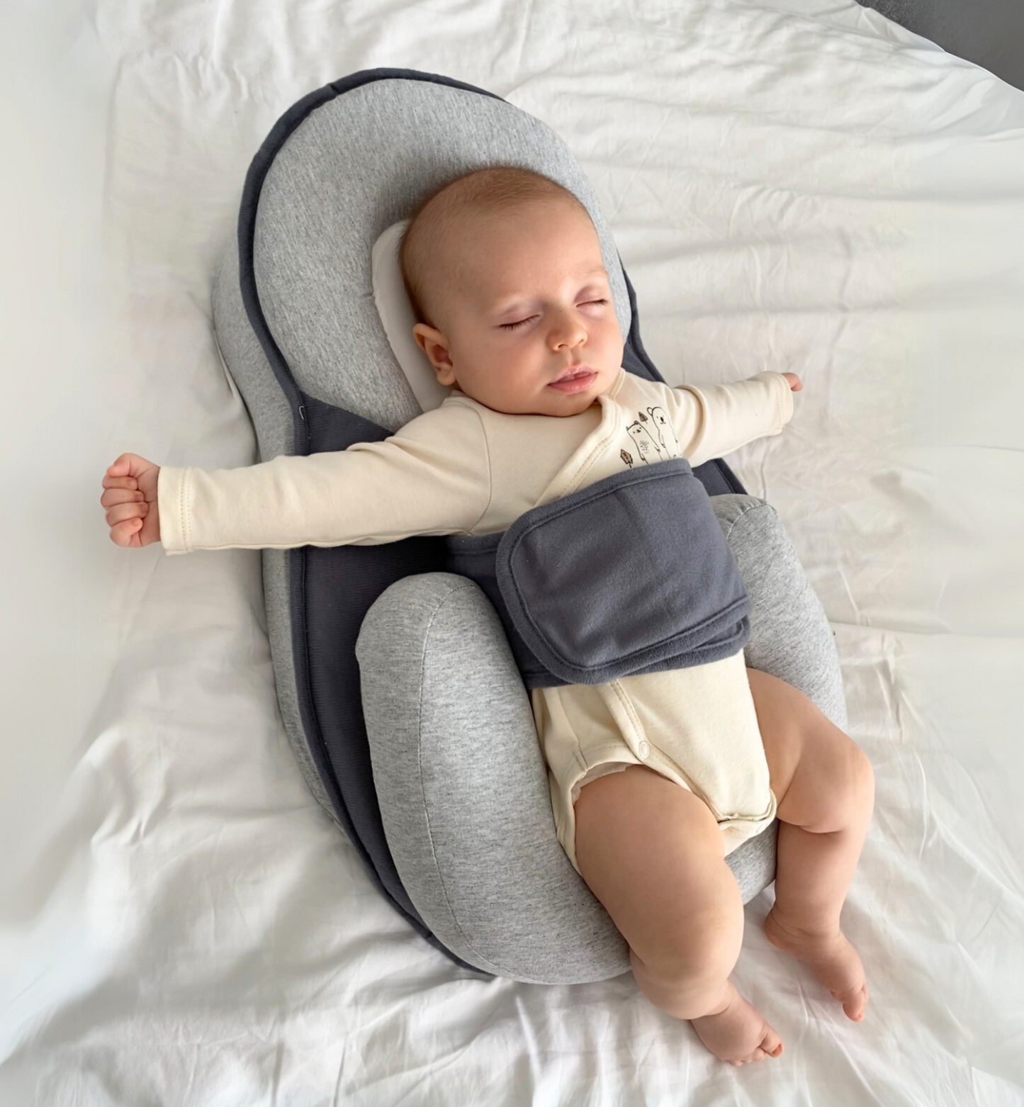 Top view of baby lying in anti-reflux lounger with safe contouring